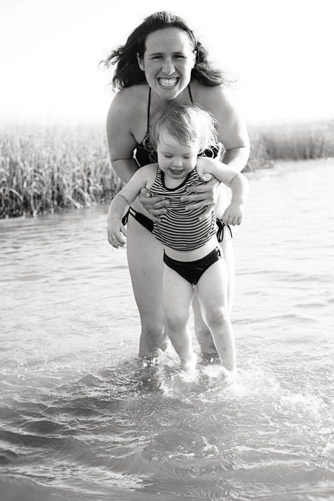 mom playing with daughter in water